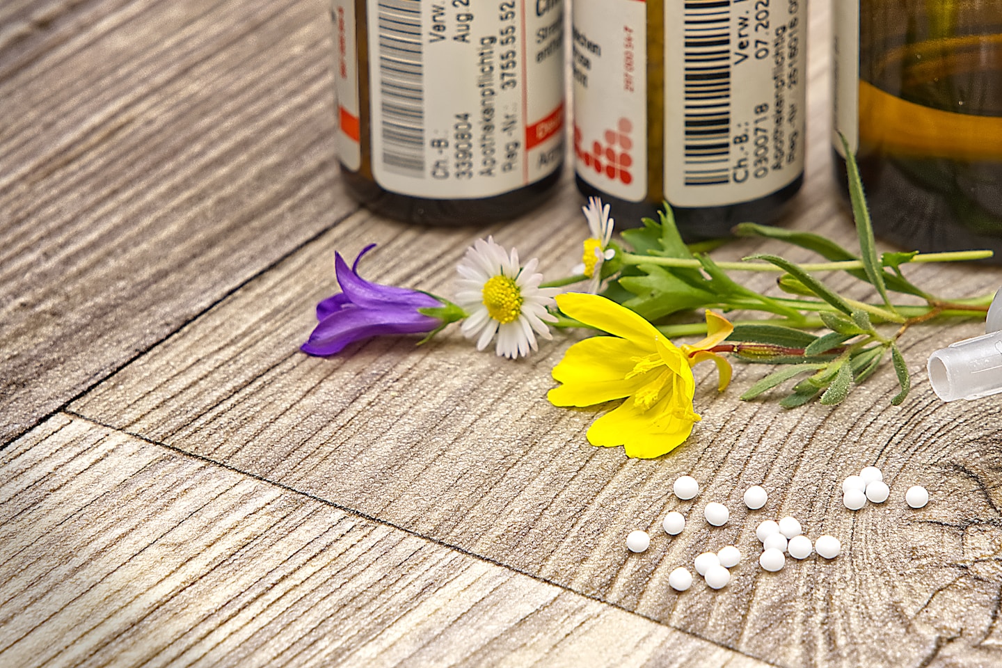 A bottle of medicine sitting on top of a wooden table